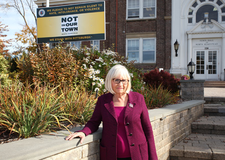 North Hempstead Town Supervisor Judi Bosworth and the Not In Our Town-We stand with Pittsburgh sign on the front lawn of Town Hall.